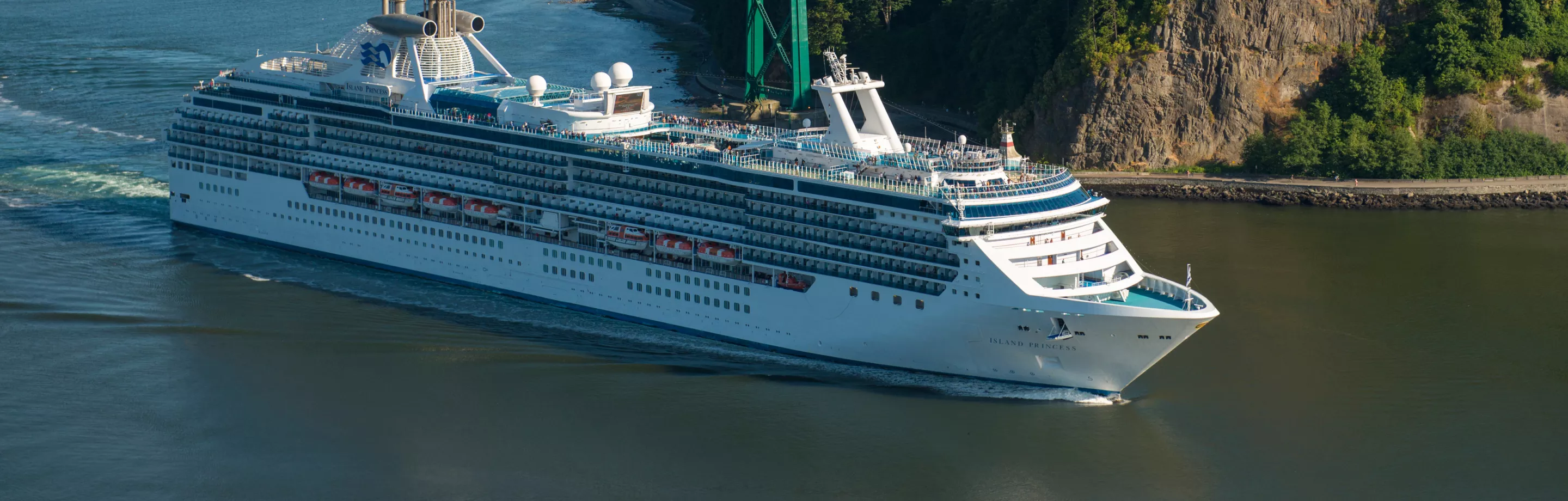 A cruise ship sails beneath the Lions Gate Bridge